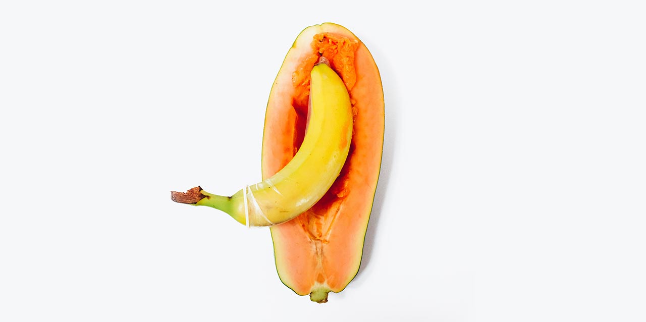 banana com preservativo em cima de papaia